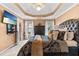 Comfortable main bedroom with a trey ceiling, warm paint, and plenty of natural light at 3229 Dunlin Lake Rd, Lawrenceville, GA 30044
