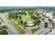 Aerial view of a well-manicured park featuring green spaces and walking paths, surrounded by roadways at 4130 Stonecypher Rd, Suwanee, GA 30024