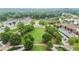 Aerial view of a lush green park surrounded by buildings and roadways in the urban environment at 4130 Stonecypher Rd, Suwanee, GA 30024