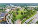 Aerial perspective of a town park, showcasing verdant lawns and walkways with lush trees at 4130 Stonecypher Rd, Suwanee, GA 30024