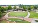 Open-air amphitheater with terraced lawn seating and stage, surrounded by trees and walkways at 4130 Stonecypher Rd, Suwanee, GA 30024