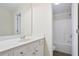 Bright bathroom featuring white vanity with a modern sink and a shower-tub combination at 4130 Stonecypher Rd, Suwanee, GA 30024
