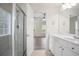 Bright bathroom features a shower and vanity, connecting to a bedroom with natural light at 4130 Stonecypher Rd, Suwanee, GA 30024