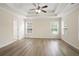 Spacious bedroom with tray ceiling, ample natural light, and modern flooring at 4130 Stonecypher Rd, Suwanee, GA 30024