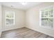 Bedroom with modern floors and two windows, offering natural light and a serene space at 4130 Stonecypher Rd, Suwanee, GA 30024