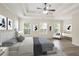Stylishly furnished bedroom featuring a plush bed, elegant decor, and ample natural light at 4130 Stonecypher Rd, Suwanee, GA 30024