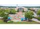 Aerial view of City Hall featuring a clock tower, fountains, manicured lawns, trees and benches at 4130 Stonecypher Rd, Suwanee, GA 30024