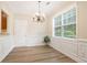 Dining room featuring elegant wainscoting, modern flooring, and a bright window at 4130 Stonecypher Rd, Suwanee, GA 30024