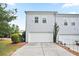 Exterior view of a two-story home with a two car garage and well-maintained lawn at 4130 Stonecypher Rd, Suwanee, GA 30024