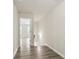 Upstairs hallway featuring modern flooring, with view into the living room with large windows at 4130 Stonecypher Rd, Suwanee, GA 30024