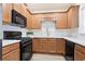 Well-equipped kitchen featuring wood cabinets, modern appliances, and elegant countertops at 4130 Stonecypher Rd, Suwanee, GA 30024