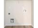 Laundry room showcasing the hookups for the dryer and the water, on hardwood style floors at 4130 Stonecypher Rd, Suwanee, GA 30024