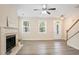 Spacious living area with fireplace, light-filled windows, and stylish staircase for a welcoming ambiance at 4130 Stonecypher Rd, Suwanee, GA 30024