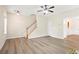 Inviting open living space with luxury flooring, a staircase, and a doorway leading to another room at 4130 Stonecypher Rd, Suwanee, GA 30024