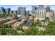 Aerial view of a residential complex surrounded by lush greenery and a bustling cityscape in the background at 1055 Piedmont Ne Ave # 401, Atlanta, GA 30309