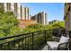 Private balcony with seating, lush greenery, and views of the surrounding buildings at 1055 Piedmont Ne Ave # 401, Atlanta, GA 30309