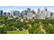 Breathtaking city skyline view from above the lush tree canopy, offering an ideal blend of nature and urban life at 1055 Piedmont Ne Ave # 401, Atlanta, GA 30309