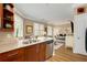 Bright kitchen featuring granite countertops, wood cabinets, stainless steel appliances, and a bar at 1055 Piedmont Ne Ave # 401, Atlanta, GA 30309