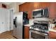 Kitchen featuring stainless steel appliances, wooden cabinets and wood-look flooring at 1055 Piedmont Ne Ave # 401, Atlanta, GA 30309