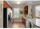 Galley kitchen featuring stainless steel appliances, wood cabinets, breakfast bar, and lots of light at 1055 Piedmont Ne Ave # 401, Atlanta, GA 30309