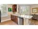 Kitchen featuring stainless steel dishwasher, wood cabinets, and a granite-top island at 1055 Piedmont Ne Ave # 401, Atlanta, GA 30309