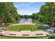 Picturesque view of a serene lake surrounded by lush trees and a charming wooden dock at 1055 Piedmont Ne Ave # 401, Atlanta, GA 30309