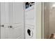 Convenient laundry closet featuring stacked washer and dryer units next to the modern bathroom at 1055 Piedmont Ne Ave # 401, Atlanta, GA 30309