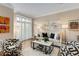 Living room features neutral tones, wood flooring and bright light from shuttered windows at 1055 Piedmont Ne Ave # 401, Atlanta, GA 30309