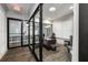 Contemporary office space with glass walls, a wooden desk, and wood-look flooring at 1055 Piedmont Ne Ave # 401, Atlanta, GA 30309