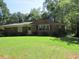 Charming brick home featuring a spacious front yard and mature trees, offering both curb appeal and privacy at 1410 Willis Mill Sw Rd, Atlanta, GA 30311