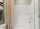 Bright bathroom featuring a tub and shower with a white surround and a patterned shower curtain at 229 Paisley Way, Locust Grove, GA 30248