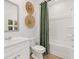 Bright bathroom featuring a shower-tub combo and fresh white fixtures and modern decor at 229 Paisley Way, Locust Grove, GA 30248