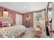 Charming bedroom featuring a bed, chair, curtains, and neutral walls at 229 Paisley Way, Locust Grove, GA 30248