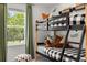 A bunk bed with a plaid pattern with a green woodland view out the window at 229 Paisley Way, Locust Grove, GA 30248