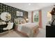 Stylish bedroom with floral wallpaper, a cozy bed, and elegant decor at 229 Paisley Way, Locust Grove, GA 30248