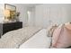 Bedroom featuring modern furniture, a dresser, and plush bedding at 229 Paisley Way, Locust Grove, GA 30248