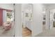 Hallway featuring views into the bathroom and a bedroom with soft pink decor at 229 Paisley Way, Locust Grove, GA 30248