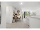 Open hallway with a desk, chair, and views into another room with green curtains at 229 Paisley Way, Locust Grove, GA 30248