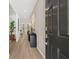 Inviting hallway with wood floors, light gray wallpaper, and modern decor at 229 Paisley Way, Locust Grove, GA 30248