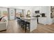 Open-concept kitchen with stainless steel appliances, a large island, and barstool seating at 229 Paisley Way, Locust Grove, GA 30248