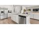 Modern kitchen with white cabinets, stainless steel appliances, and open living space at 229 Paisley Way, Locust Grove, GA 30248