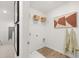 Functional laundry room featuring a floating shelf, artwork, and a neutral color palette at 229 Paisley Way, Locust Grove, GA 30248