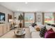 Spacious living room featuring a comfortable sofa and views of the well-maintained backyard at 229 Paisley Way, Locust Grove, GA 30248