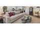 Open-concept living room with view to kitchen featuring contemporary decor and stylish furniture at 229 Paisley Way, Locust Grove, GA 30248
