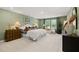Spacious main bedroom with ample natural light and a sitting area by the window at 229 Paisley Way, Locust Grove, GA 30248