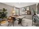 Comfortable office space with large desk, art wall, neutral wallpaper and a fiddle leaf fig tree at 229 Paisley Way, Locust Grove, GA 30248