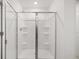 Modern shower featuring a glass door and built-in shelving at 229 Paisley Way, Locust Grove, GA 30248