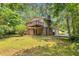 View of the home's rear elevation, showing a private deck and access to a spacious, wooded backyard at 3357 Huntwood Ct, Decatur, GA 30034
