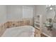 A relaxing soaking tub and modern glass bowl sink at 3357 Huntwood Ct, Decatur, GA 30034