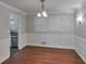 Elegant dining room with beautiful wainscoting, hardwood floors, and a stylish chandelier at 3357 Huntwood Ct, Decatur, GA 30034